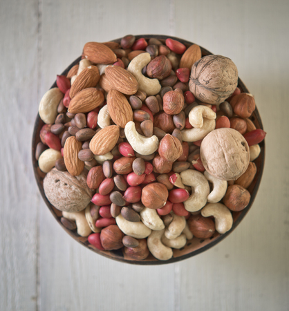 Assorted nuts in wooden bowlの写真素材