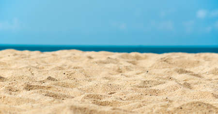 Sand beach against blue skyの写真素材
