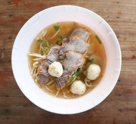Asian noodle soup on a wooden tableの写真素材