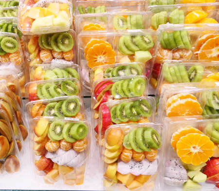Fresh sliced fruits in plastic boxの写真素材