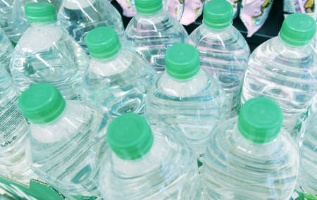 Close up shot of plastic bottles with waterの写真素材