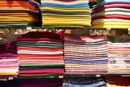 Stacks of colorful headscarfs and textileの写真素材