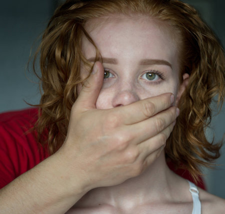 Man covering mouth of young womanの写真素材