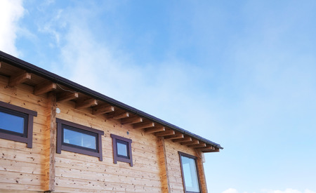 Roof of cabin against blue sky