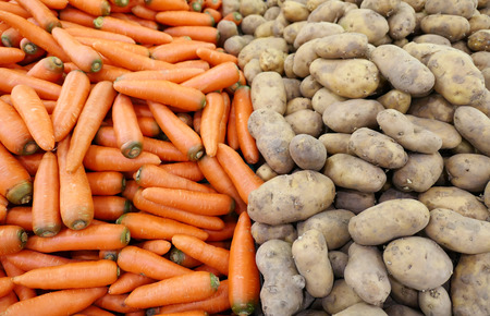 Fresh carrot and potato at a marketの写真素材