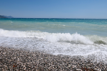 Pebble beach and stormy seaの写真素材