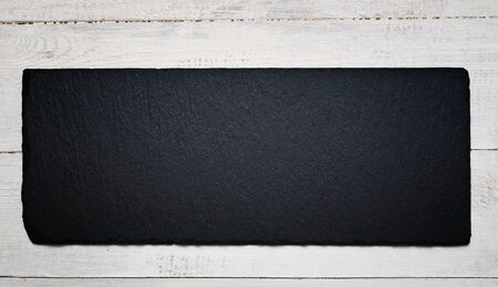 Slate black plate on wooden