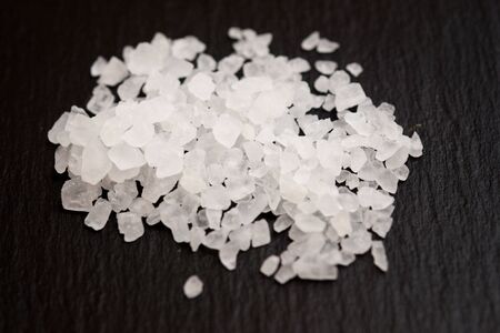 Heap of sea salt on  black