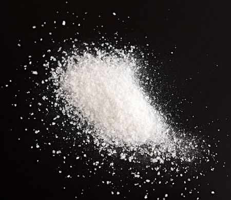 Heap of sea salt on  black