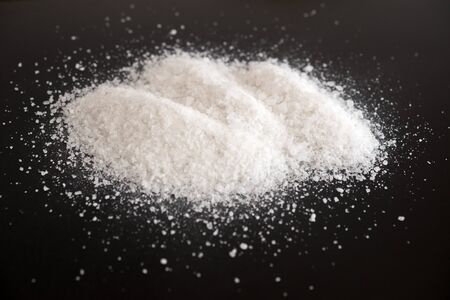 Pile of salt on a black backgroundの写真素材