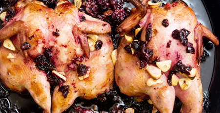 Roasted quails with black currant and garlicの写真素材