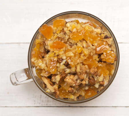 Healthy mixture of honey, dried apricots, walnut and lemonの写真素材