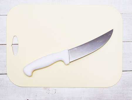 Plastic cutting board and kitchen knifeの写真素材