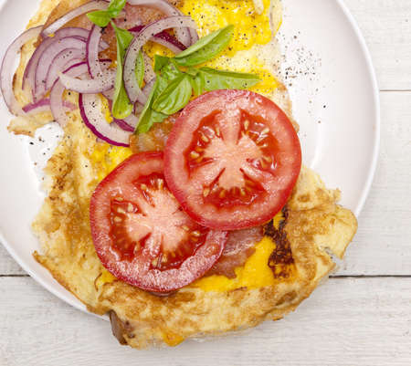 Fried eggs with bacon and vegetables, top viewの写真素材