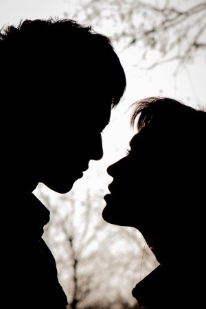 Profiles of romantic couple looking at each otherの写真素材