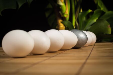 Silver and white Easter eggs with wood backgroundの写真素材