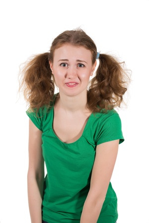 portrait of offended woman in green dress over whiteの写真素材