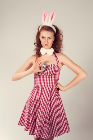 sexy girl wearing easter bunny costume with eggの写真素材