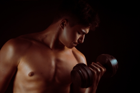 Musculed man model posing in studioの写真素材