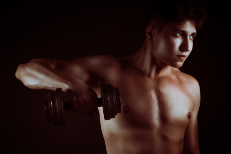 Musculed man model posing in studioの写真素材
