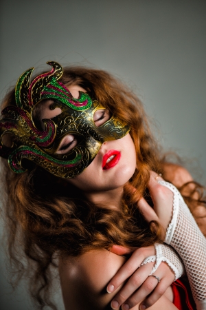 Beautiful Girl in Carnival mask with long curly hair  Masquerade Holidaysの写真素材