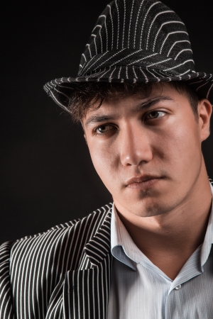 a man in a grey hat on black backgroundの写真素材