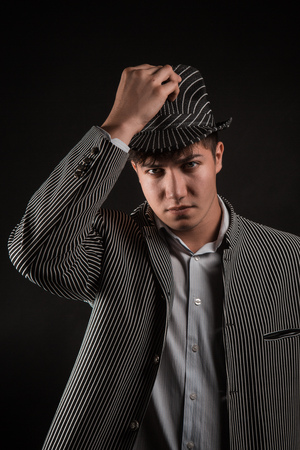 a man in a grey hat on black backgroundの写真素材