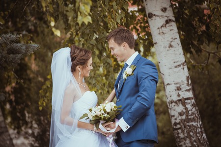 Young wedding couple kissing. Bright white colors.の写真素材