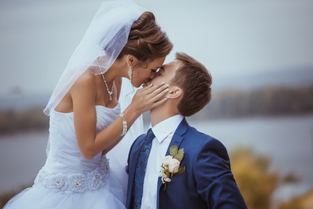 Young wedding couple kissing. Bright white colors.の写真素材