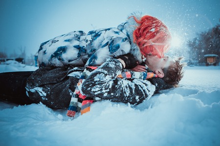 Happy Young Couple in Winter Park having fun.Family Outdoors. love kissの写真素材