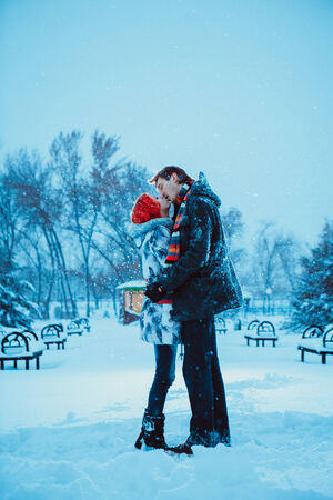 Happy Young Couple in Winter Parkの写真素材