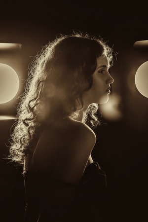 A black and white image of a beautiful young woman with flowing hair.
