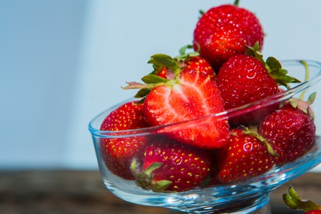 isolated strawberry isolated on rustic wooden backgroundの写真素材