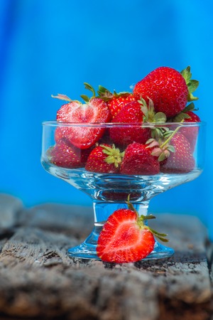 isolated strawberry isolated on rustic wooden backgroundの写真素材