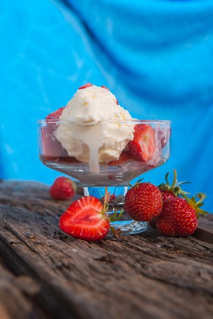 Ice cream with strawberries and whipped creamの写真素材