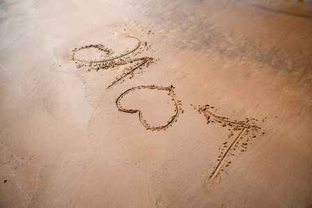 The word LOVE on sand.の写真素材