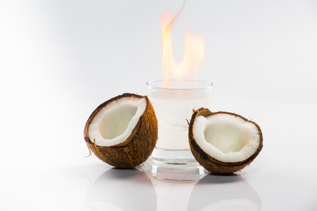 Coconut cocktail on white background with mint and fireの写真素材