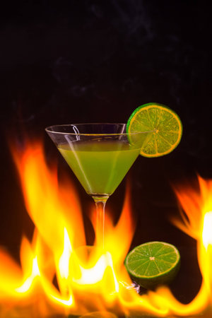 Burning alcoholic drink with ice cubes, isolated on black backgroundの写真素材