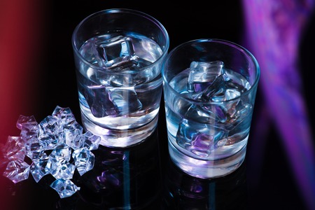 Two glasses of vodka with ice cubesの写真素材