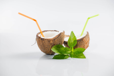 Coconut cocktail on white background with mintの写真素材
