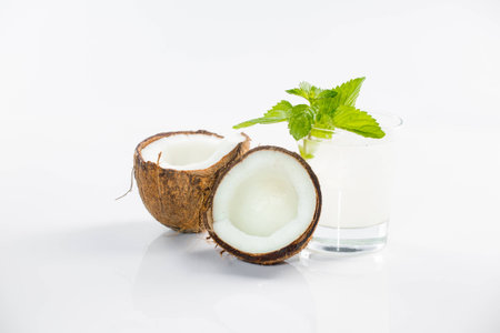 Coconut cocktail on white background with mint