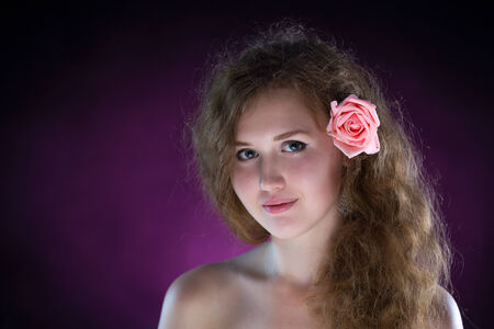 Studio portrait of young beautiful woman with roses in the smokeの写真素材