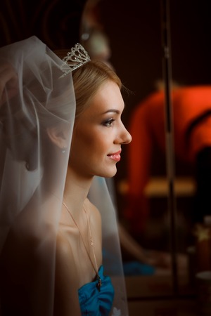 bride in a beautiful dress near the  windowの写真素材