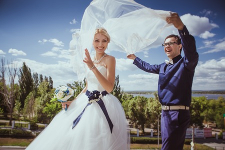 Newly wed couple dancing next to a lakeの写真素材