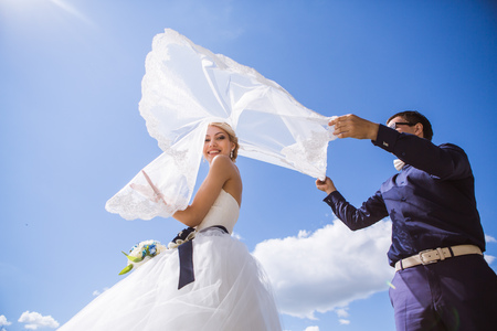 Newly wed couple dancing next to a lakeの写真素材