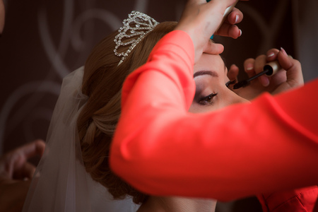 Stylist makes makeup bride on the wedding dayの写真素材
