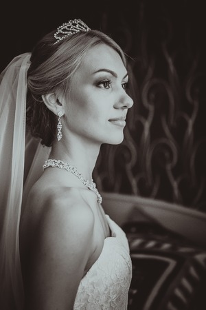 bride in a beautiful dress near the  windowの写真素材