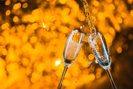 Glasses of champagne with  splashの写真素材