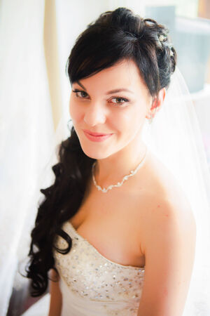 Happy beautiful bride blond girl in  white wedding dress with hairstyleの写真素材