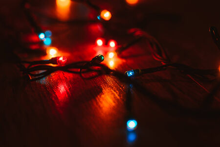 Christmas lights on wooden background.  Selective focusの写真素材
